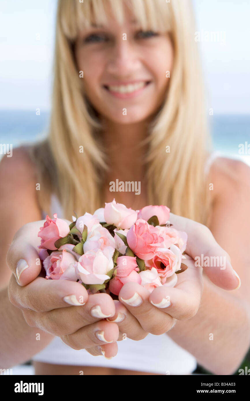 Woman holding a handful of roses Stock Photo