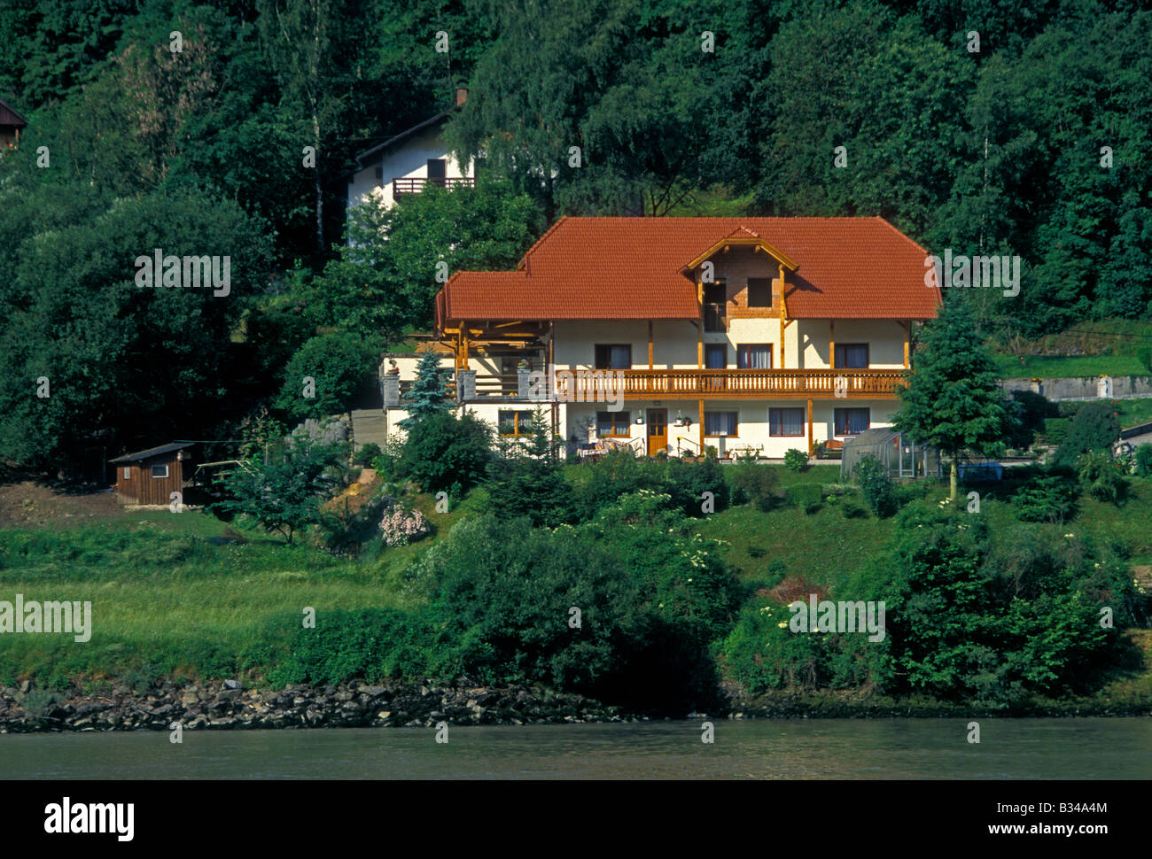 Riverfront riverside home house residence dwelling Danube River town of Engelhartszell Upper Austria State Austria Europe Stock Photo