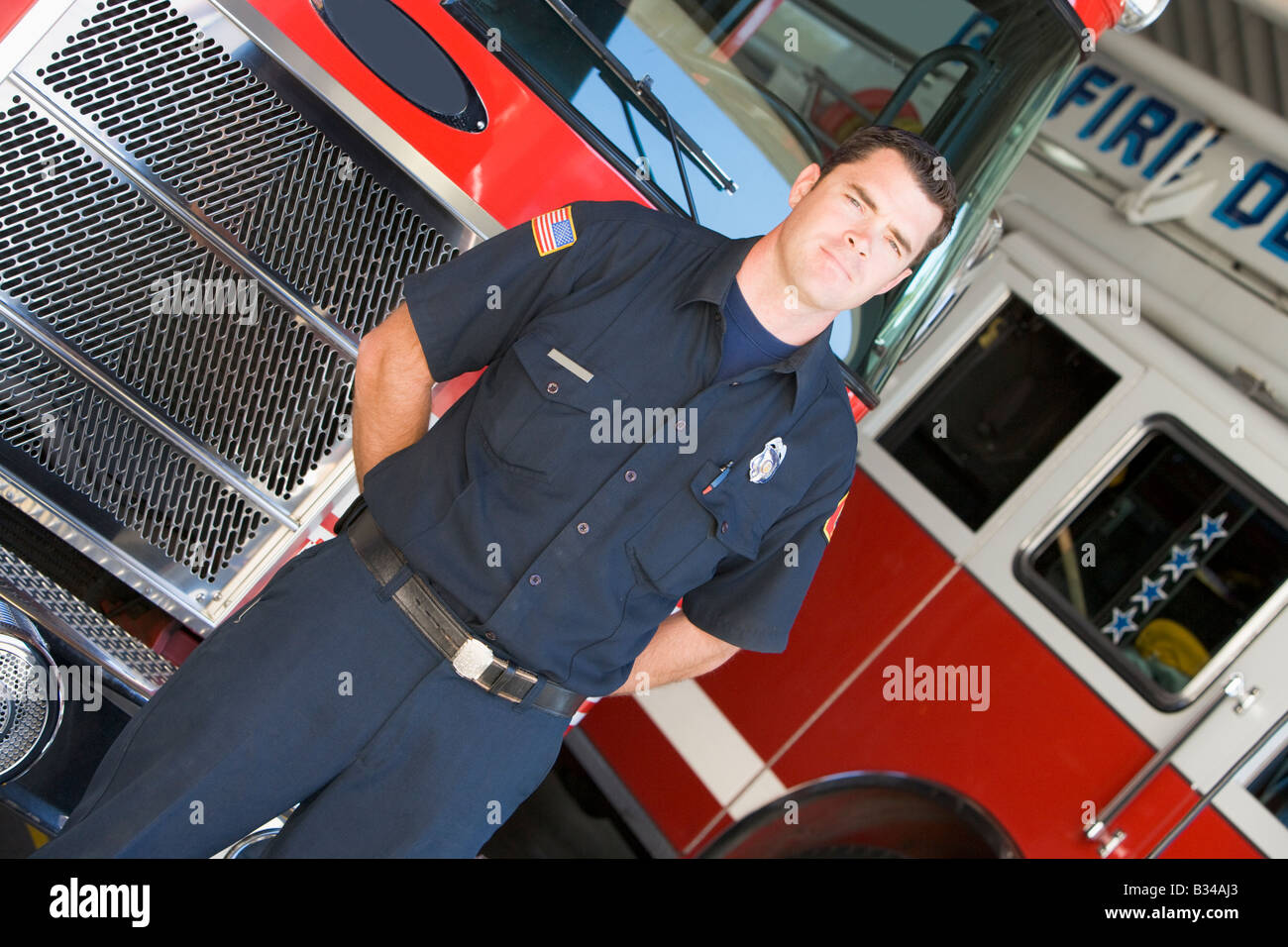 Fireman standing in front of fire engines Stock Photo