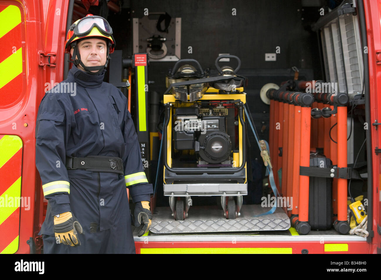 Rescue worker standing by open back door of rescue vehicle Stock Photo