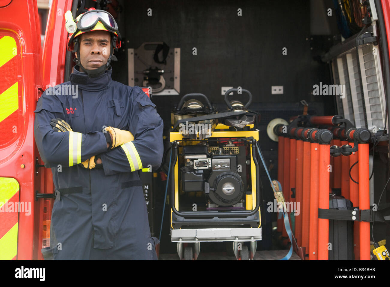 Rescue worker standing by open back door of rescue vehicle Stock Photo
