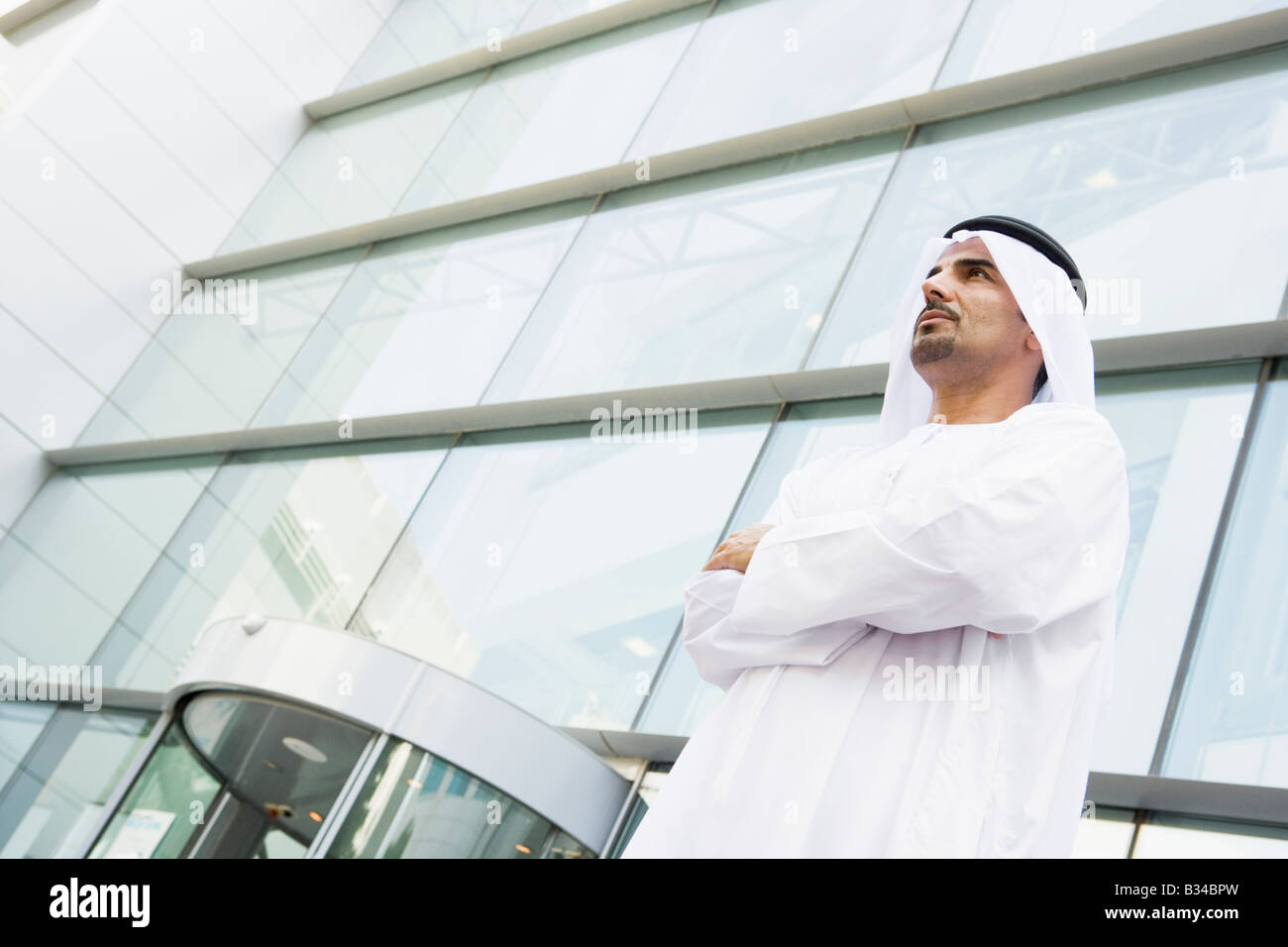 Businessman standing outdoors by building Stock Photo