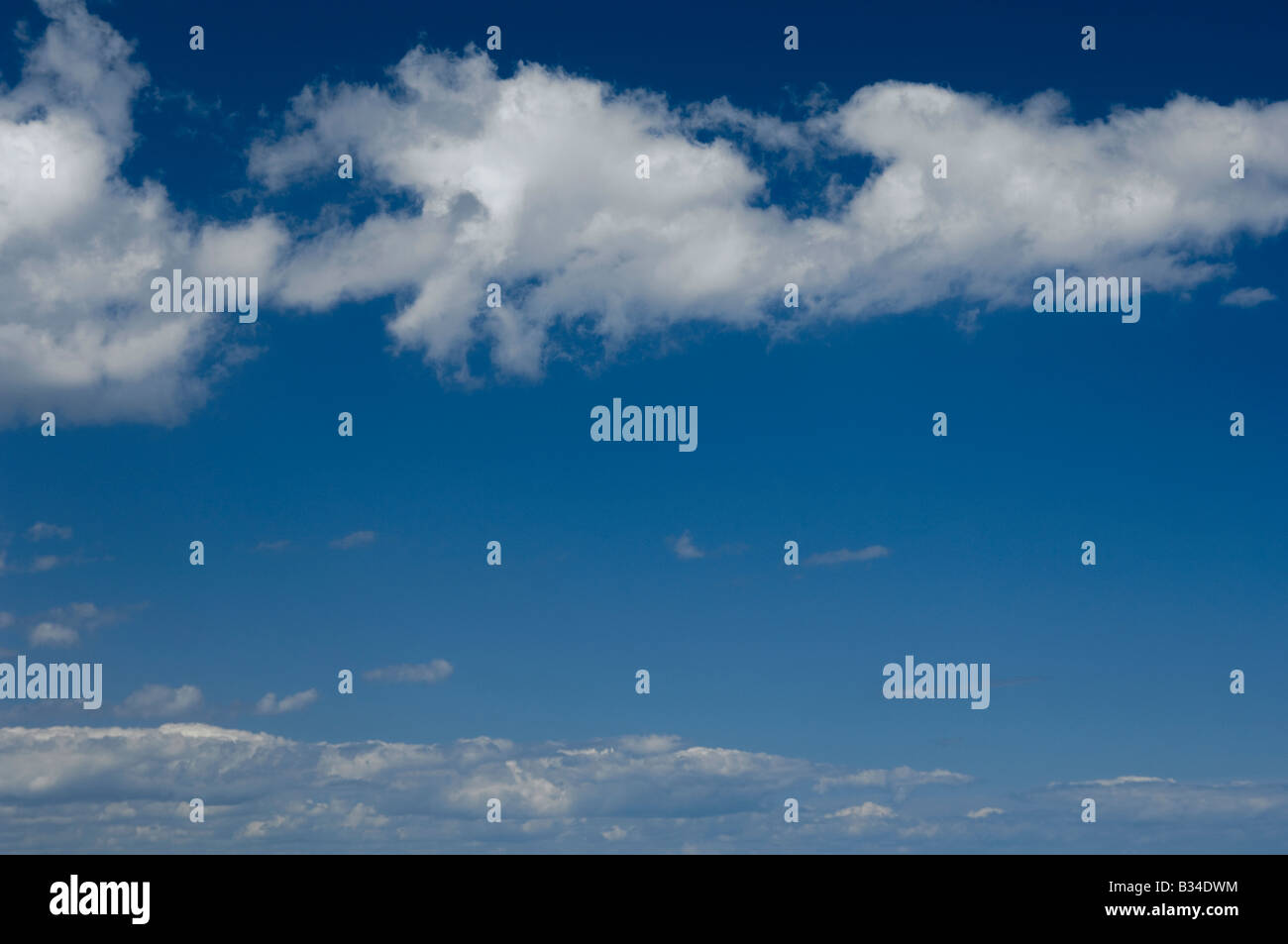 Fluffy clouds in a blue sky Stock Photo - Alamy