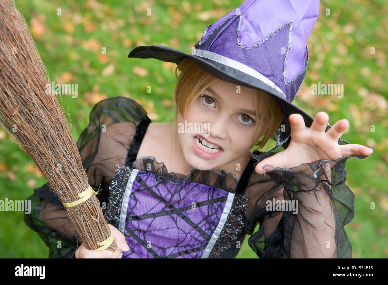 Young girl outdoors in witch costume on Halloween Stock Photo