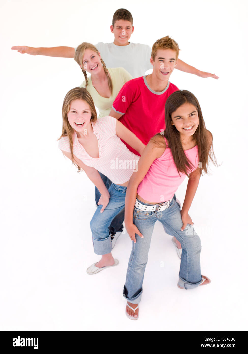 Five friends in a row smiling Stock Photo