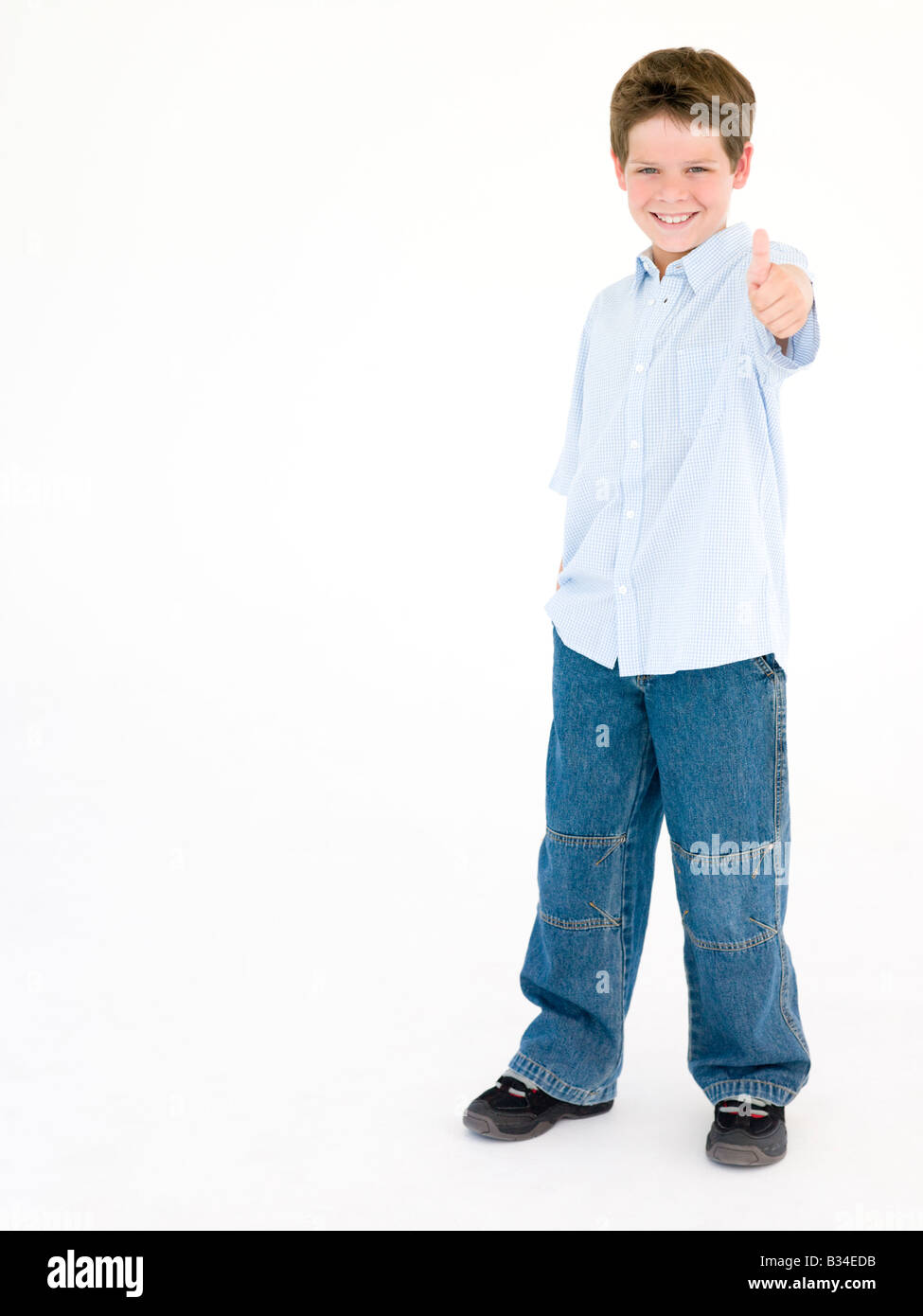 Young boy giving thumbs up smiling Stock Photo - Alamy