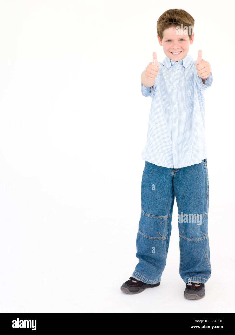 Young boy giving thumbs up smiling Stock Photo - Alamy