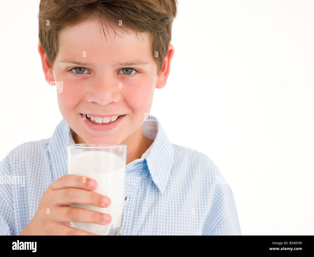 Young boy with glass of milk smiling Stock Photo Alamy
