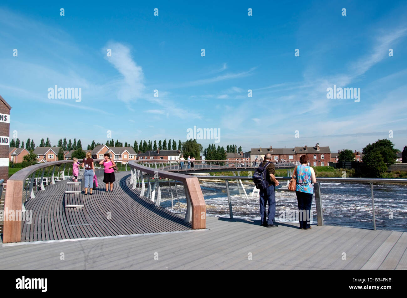 People on the platform of the new footbridge between Aire Street and