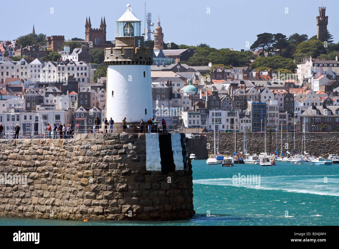 The Lighthouse Breakwater and St Peter Port in Guernsey Stock Photo