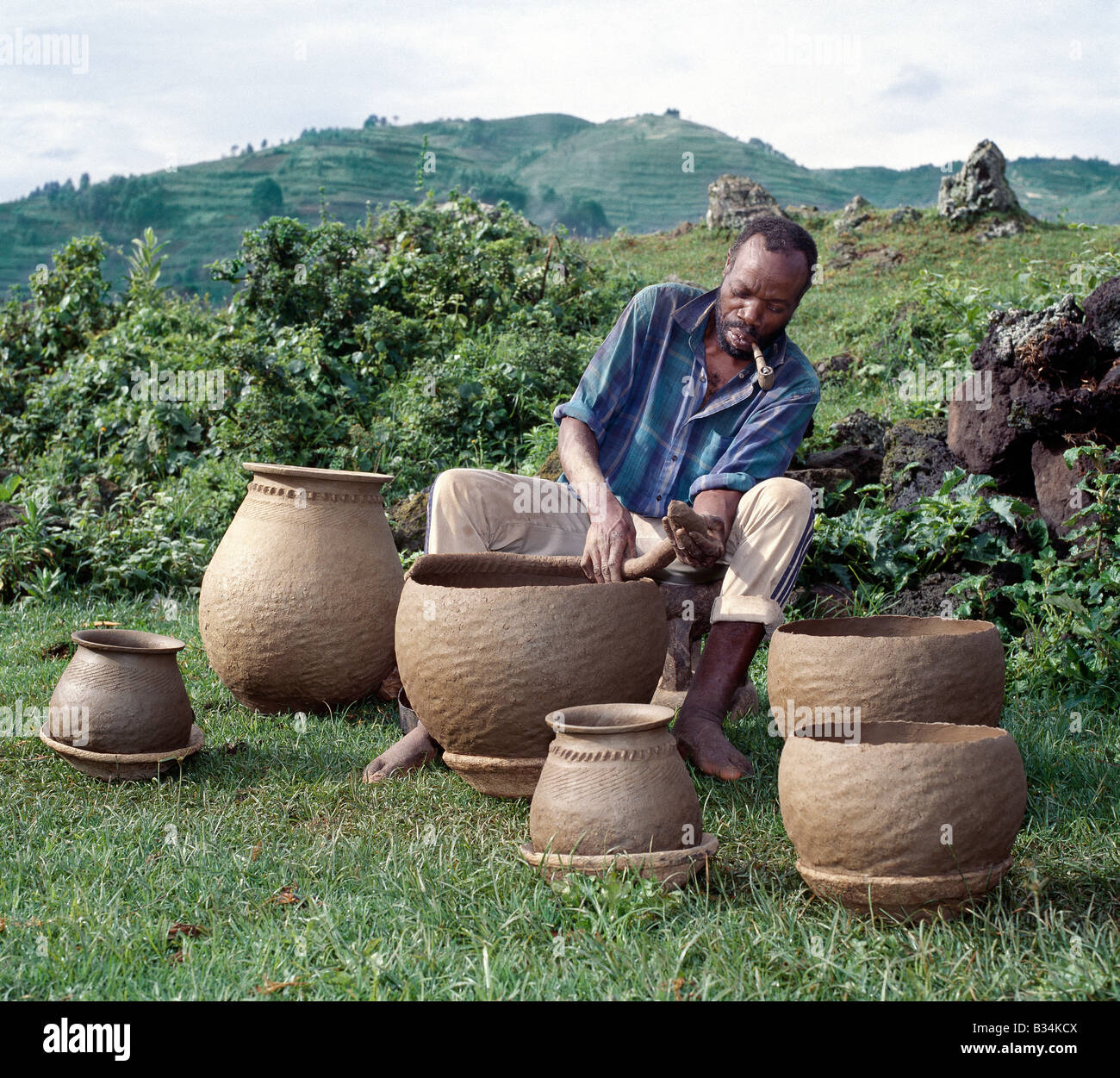 Uganda, Southwest Uganda, Muko. A potter fashions cooking pots by the