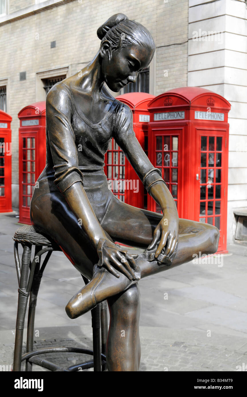UK.Statue of Young Dancer by telephone boxes outside the Royal Opera