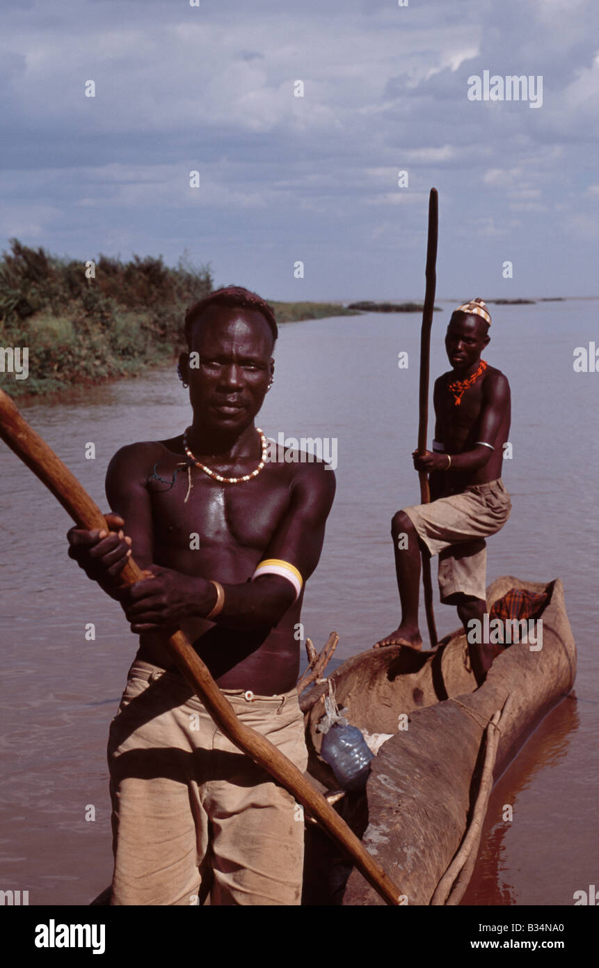 Kenya, Omo Delta, Lake Turkana. El Molo fishermen in their dugout canoe on the fringe of the Omo Delta. The El Molo are reputedly Kenya's smallest tribe, a group of nomadic fishermen who fish the Omo delta and Lake turkana. Stock Photo