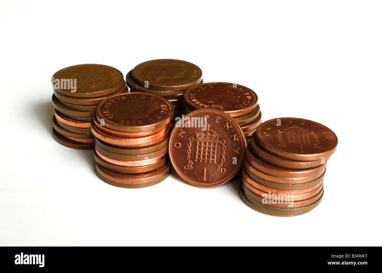 Piles of penny copper coins, with 1p  ( one pence ) standing.  ( Sterling ) Stock Photo