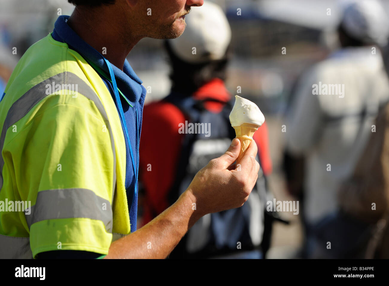 An Eastbourne council employee walking with an ice cream during a snack break. Picture by Jim Holden Stock Photo
