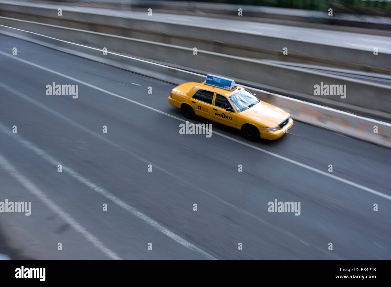 A lone NYC taxi driving on the West Side Highway in Manhattan, NY. Stock Photo