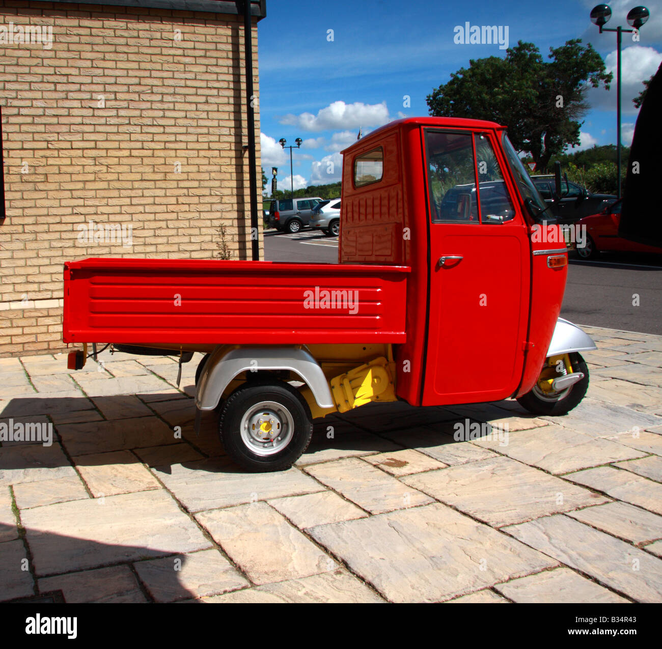 A full profile view of a red and silver Piaggio Ape 500 pick up Stock Photo  - Alamy