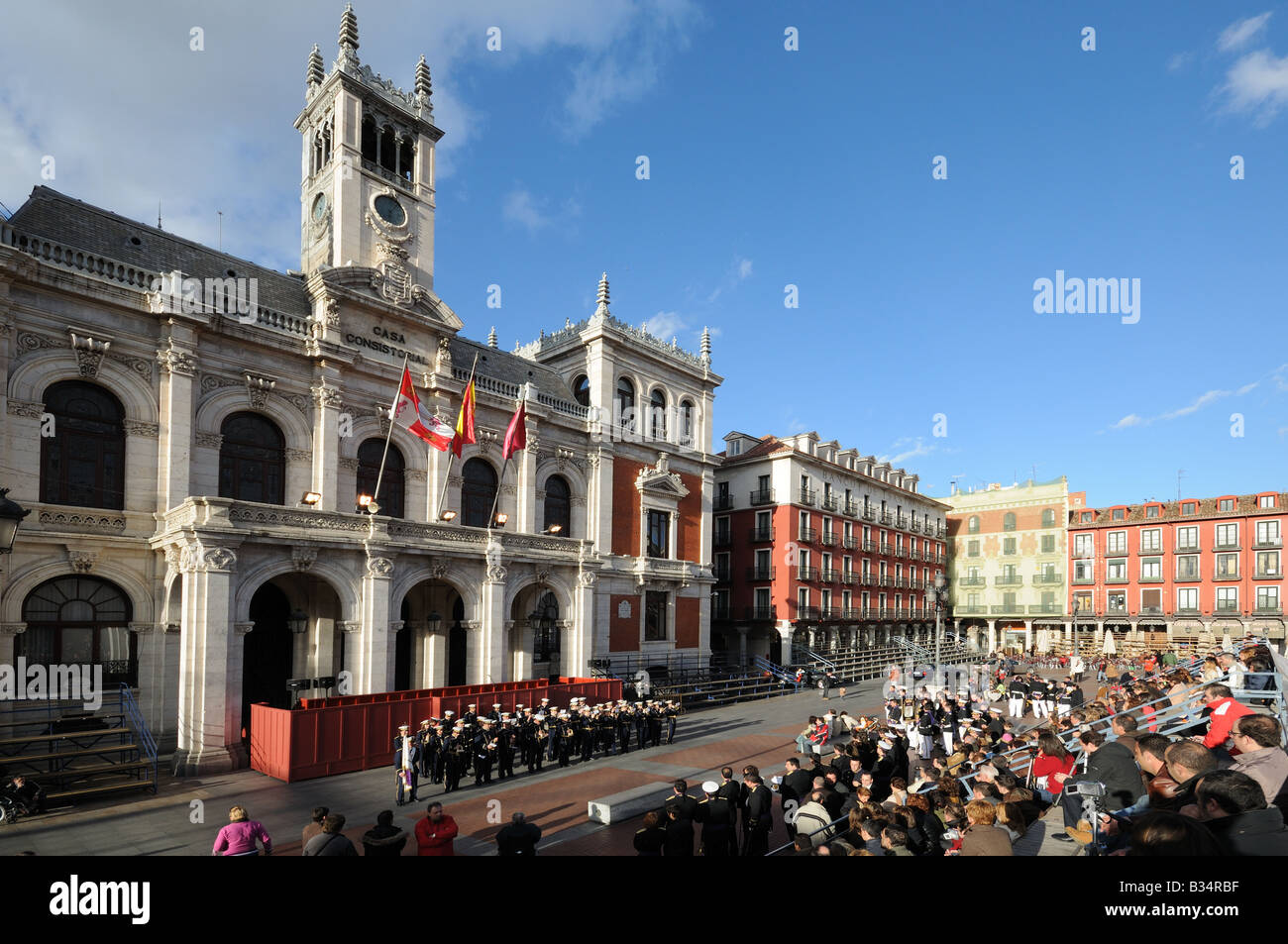 A miltary style brass band playing music in front of the CASA CONSISTORIAL or Town Hall City Council building in the main square Stock Photo