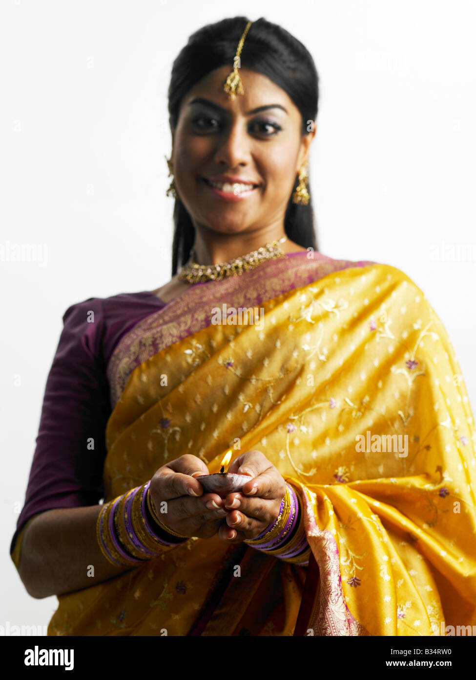 An indian woman holding oil lamp Stock Photo Alamy