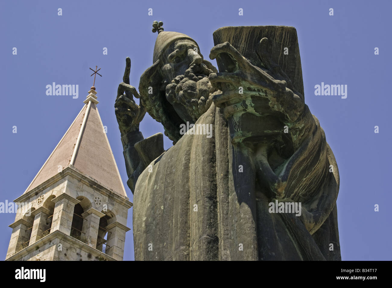 Split's Gregory of Nin statue, by sculptor Ivan Mestrovic, with tower of Diocletian's Palace Stock Photo