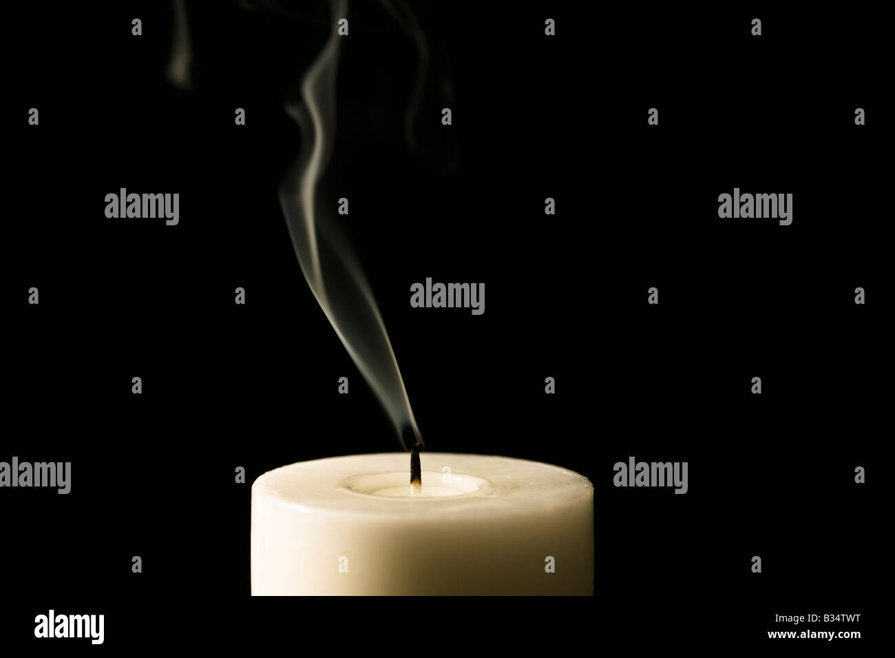 Candle just blown out showing smoke trail Stock Photo Alamy