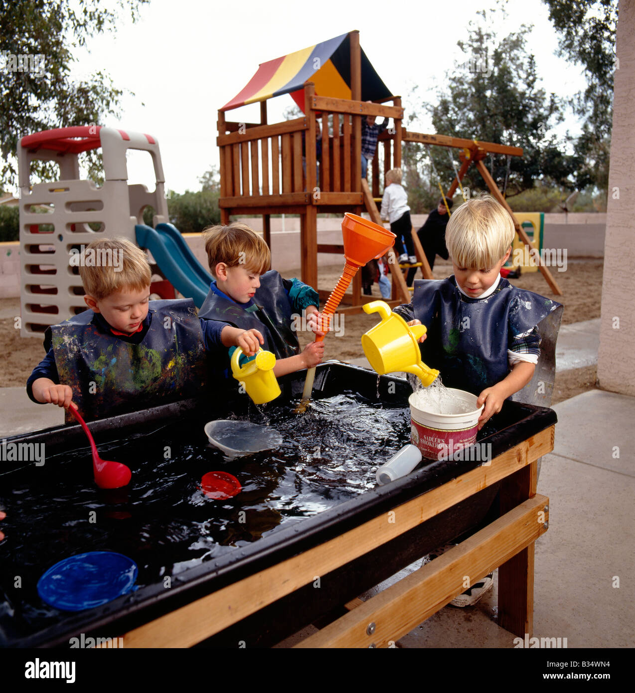 Young children playing at a water table game in an Arizona preschool