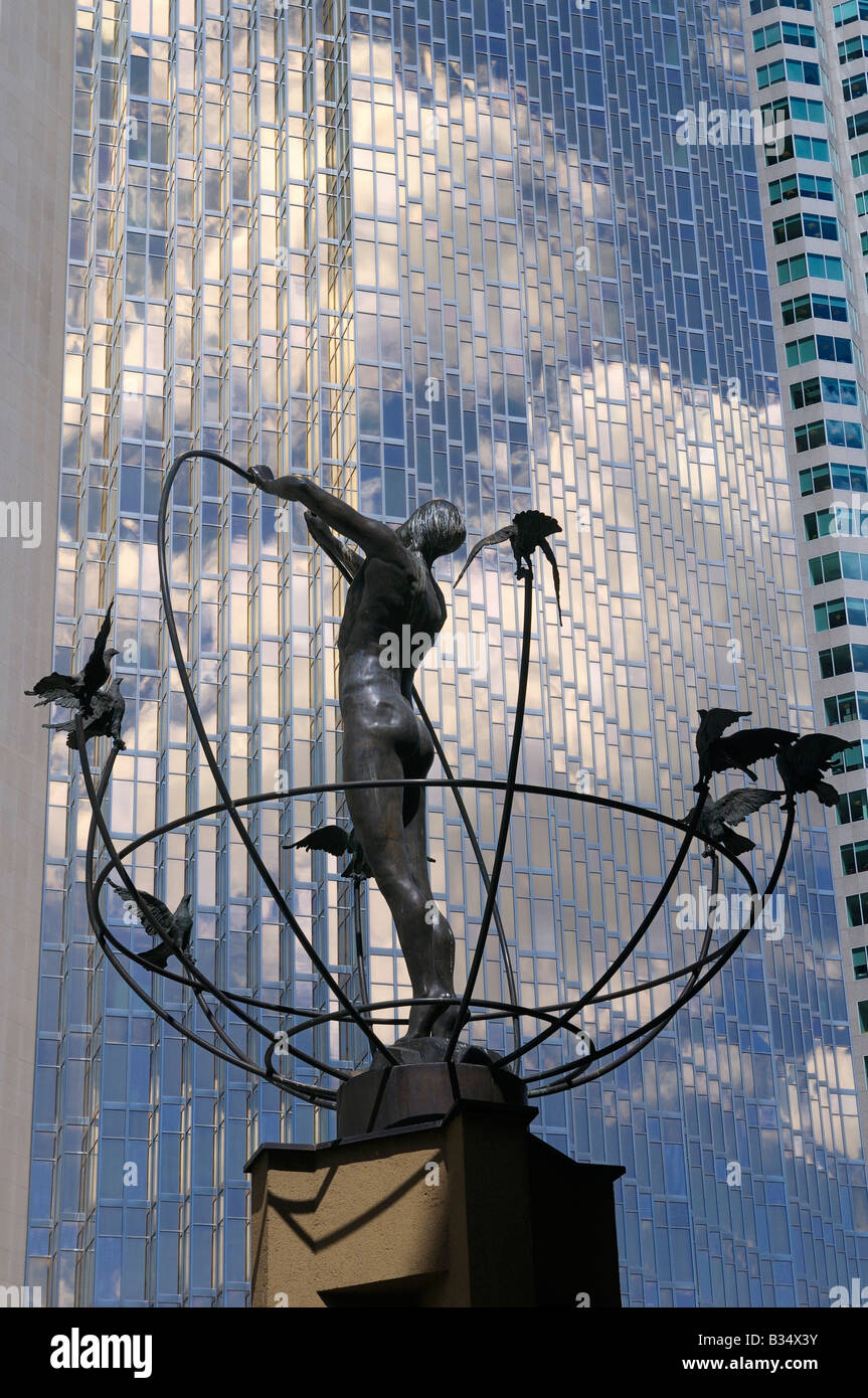 Toronto sculpture of a man building global peace against gold glass