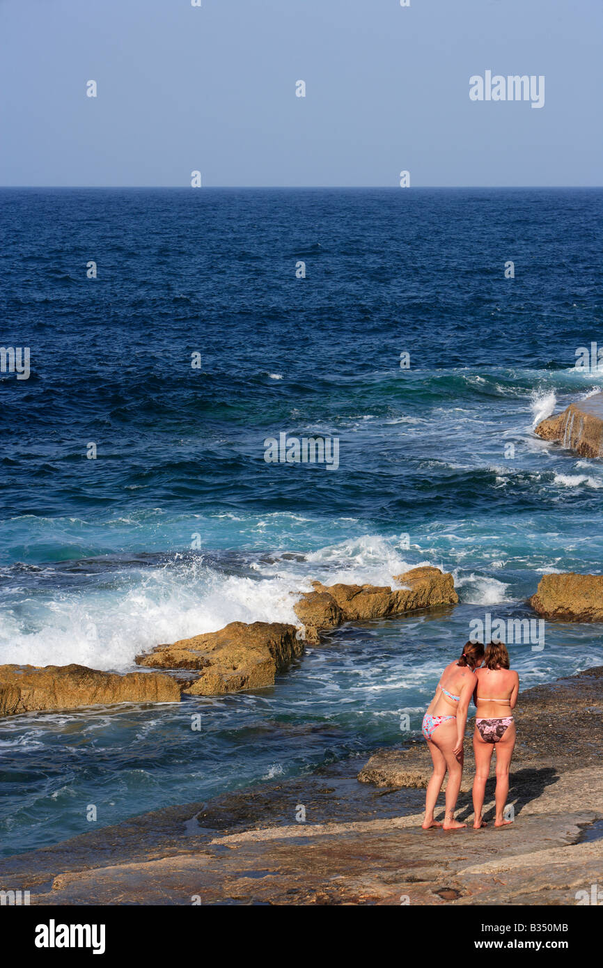 Bathing on rocky beach at Sliema Malta Stock Photo