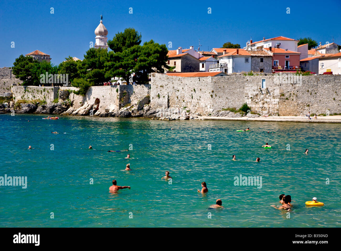 Bathing in the bay at the town Krk in Croatia Stock Photo - Alamy