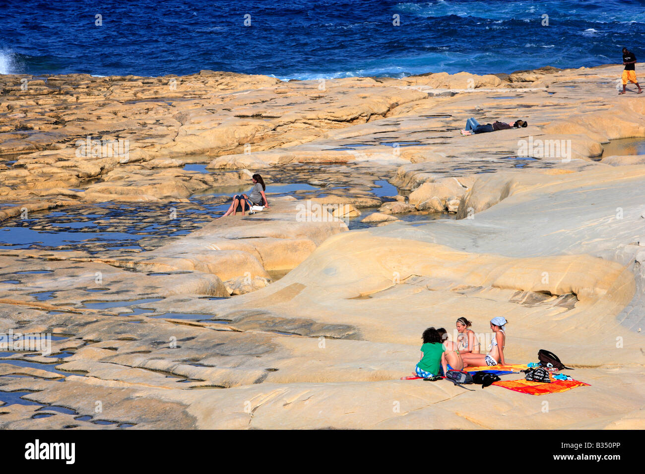 Sunbathing on Sliema beach, Malta Stock Photo