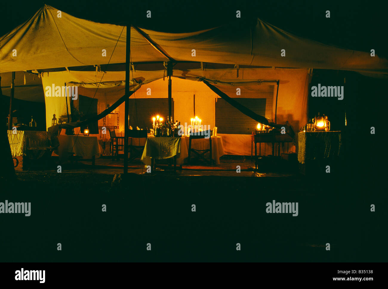 Kenya, Masai Mara. Table laid for dinner in the main dining tent, Cottar's 1920s Camp. Stock Photo