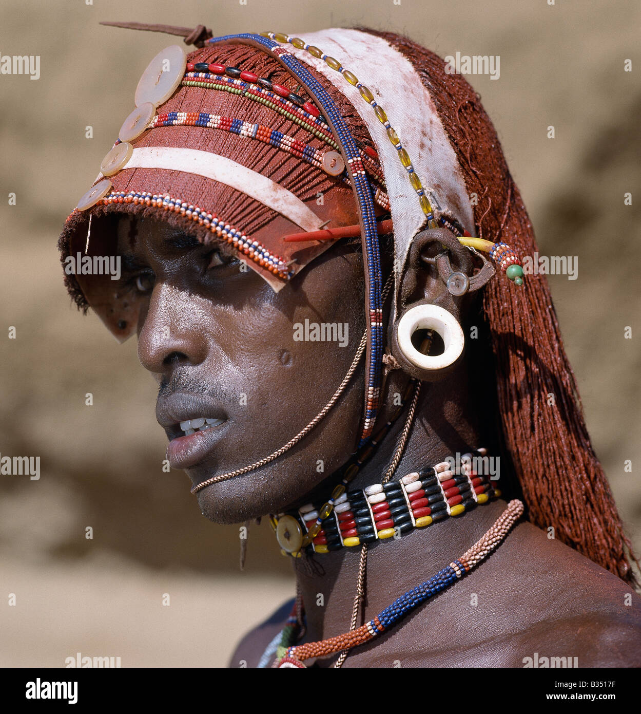 Kenya, Maralal, Barsaloi. A Samburu warrior resplendent with long, braided, Ochred hair. Stock Photo