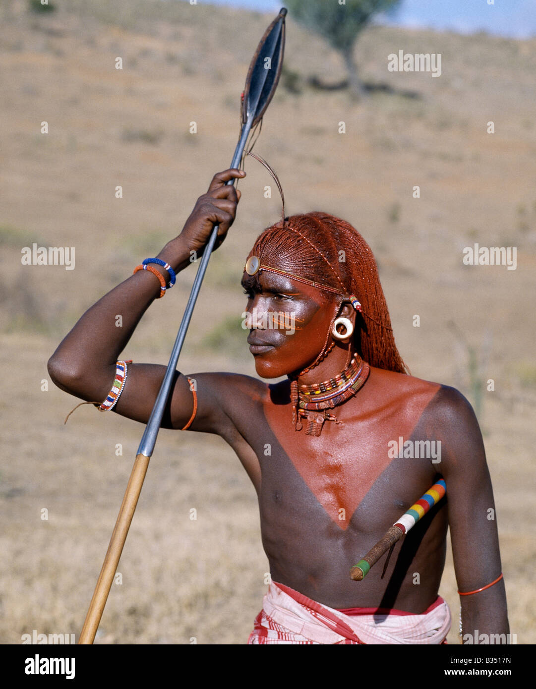 Kenya, Maralal, Maralal. A Samburu warrior resplendent with long braids of Ochred hair. Stock Photo