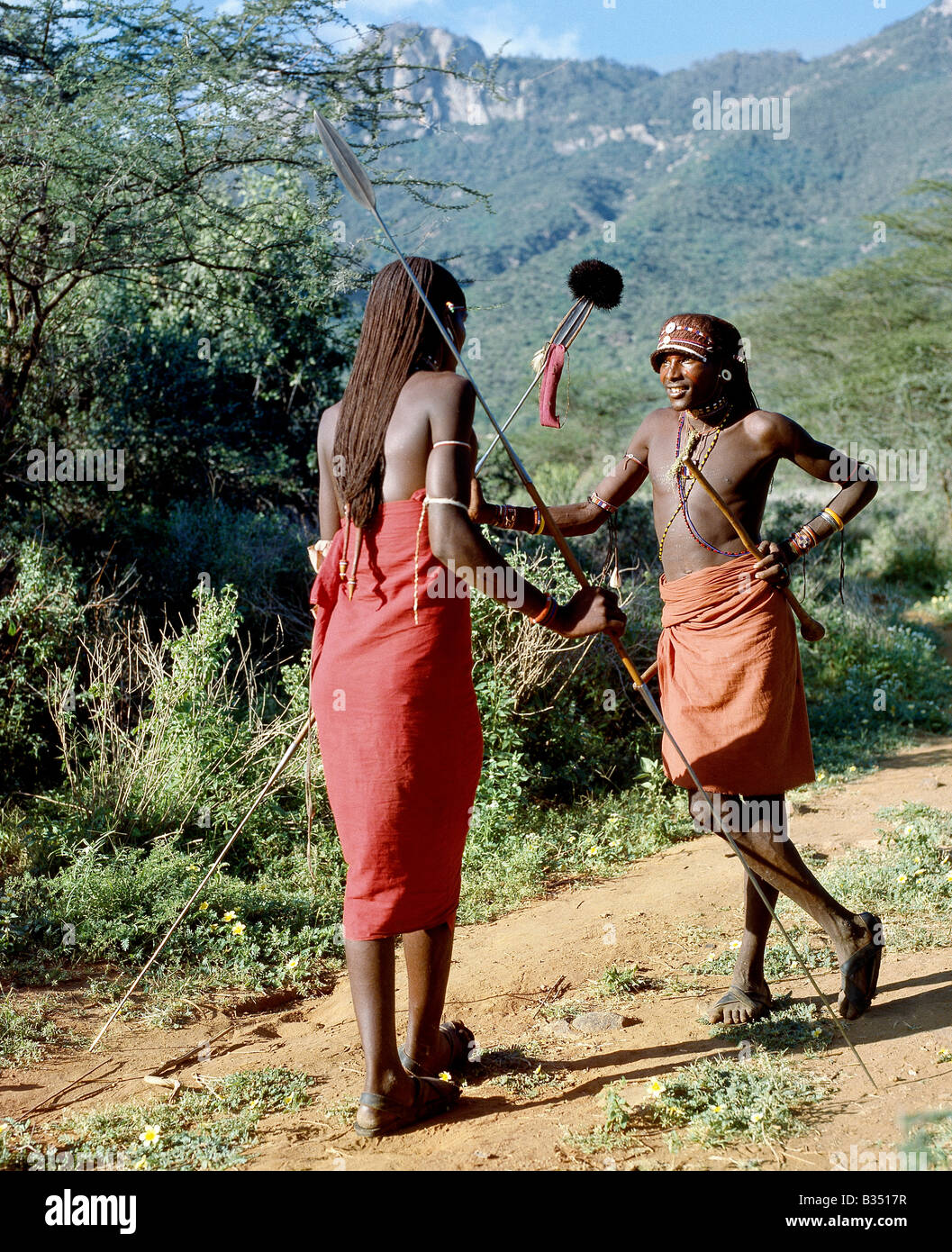 Kenya, South Horr, South Horr Valley. Two Samburu warriors converse, their long braids of Ochred hair distinguishing them Stock Photo
