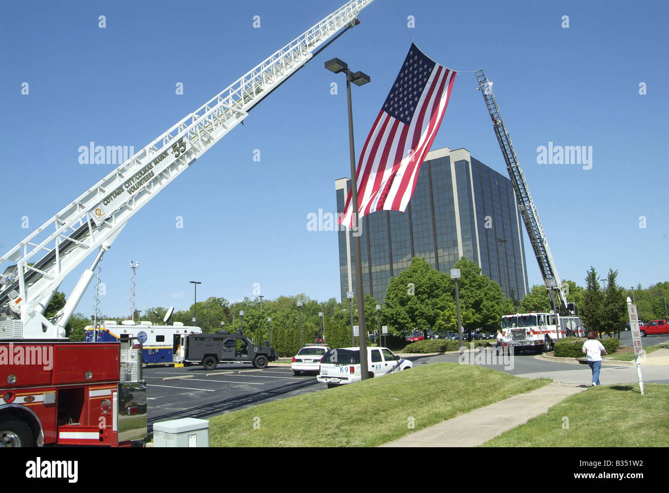 Fire Department ladder units frame an arch with an American flag in the middle  at the entrance to the Fire & Police Awards Stock Photo