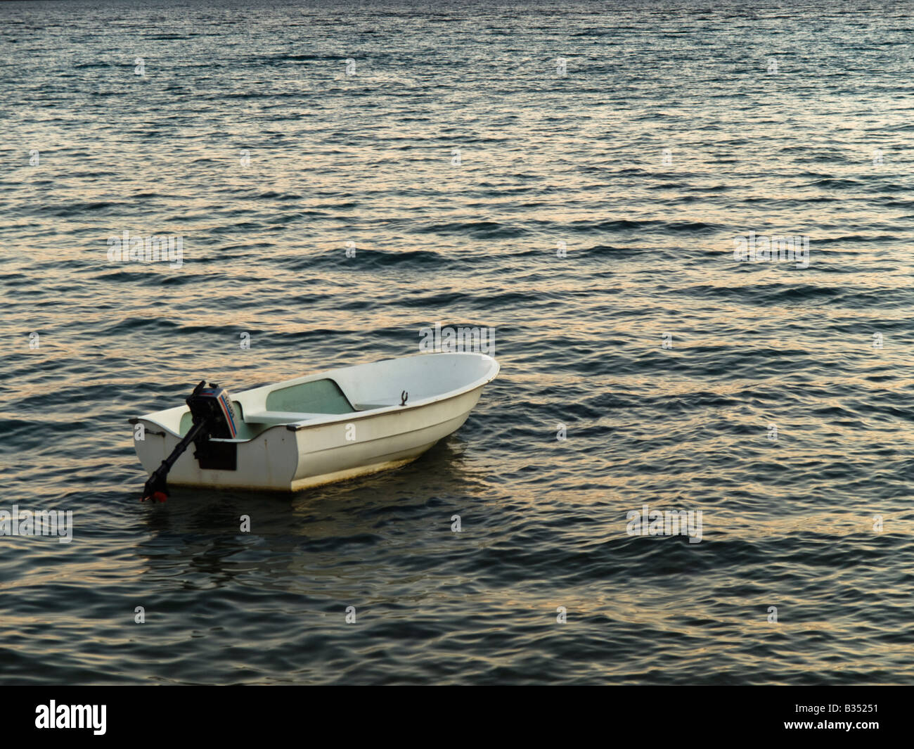 A lone plastic motorboat in the murky sea. Stock Photo