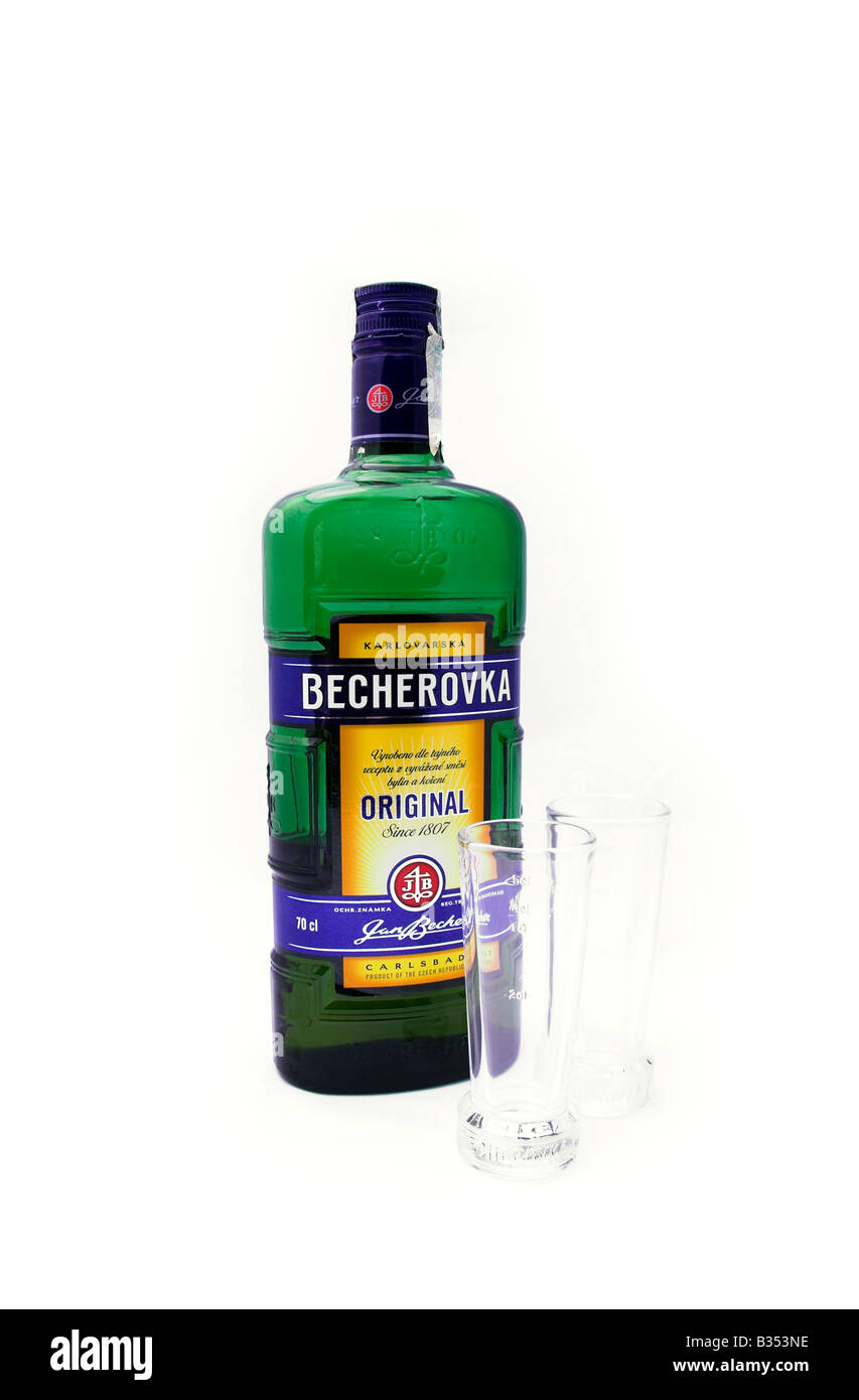 Bottle of Becherovka and shot glasses, white background Stock Photo
