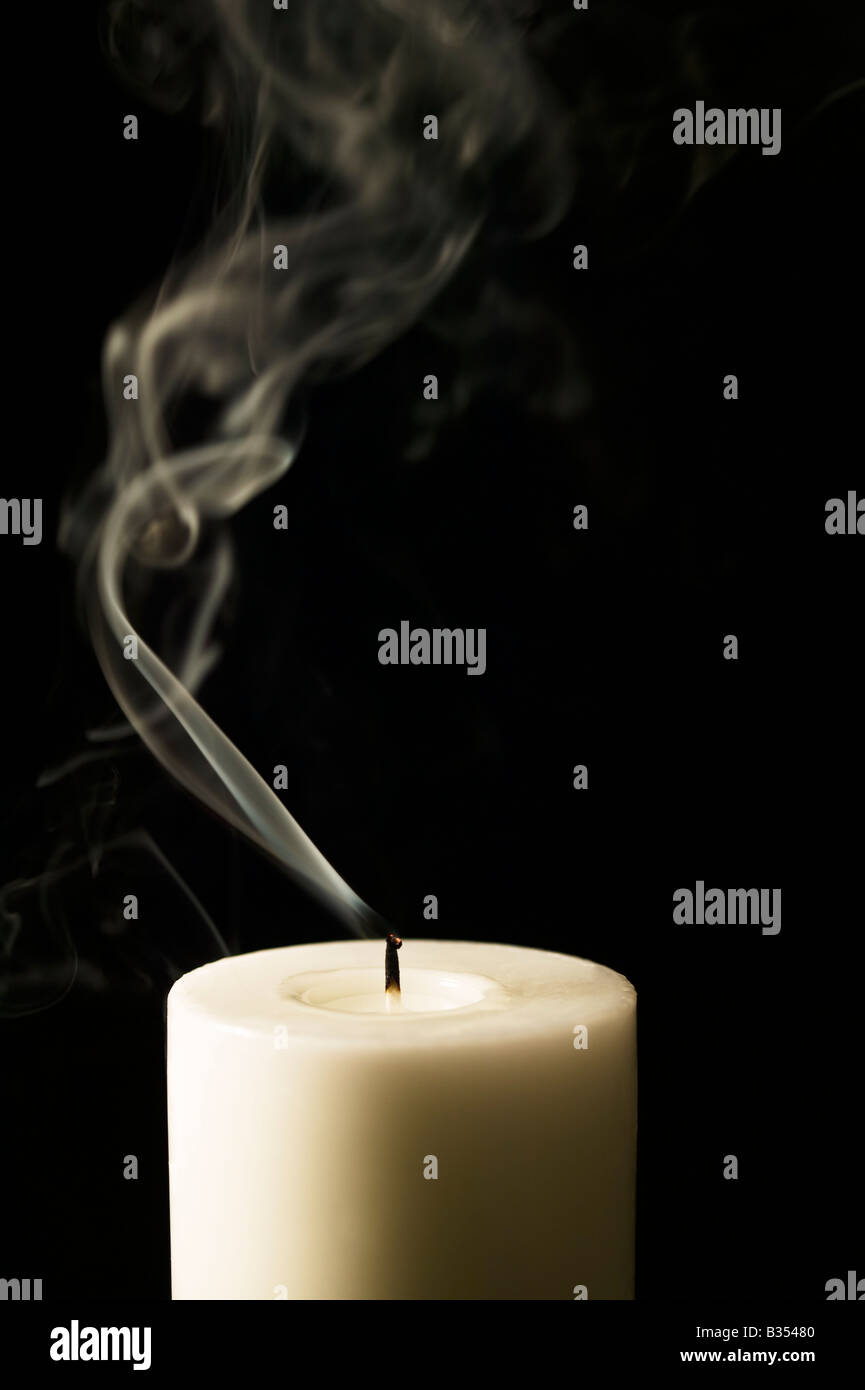 Candle just blown out showing smoke trail Stock Photo Alamy