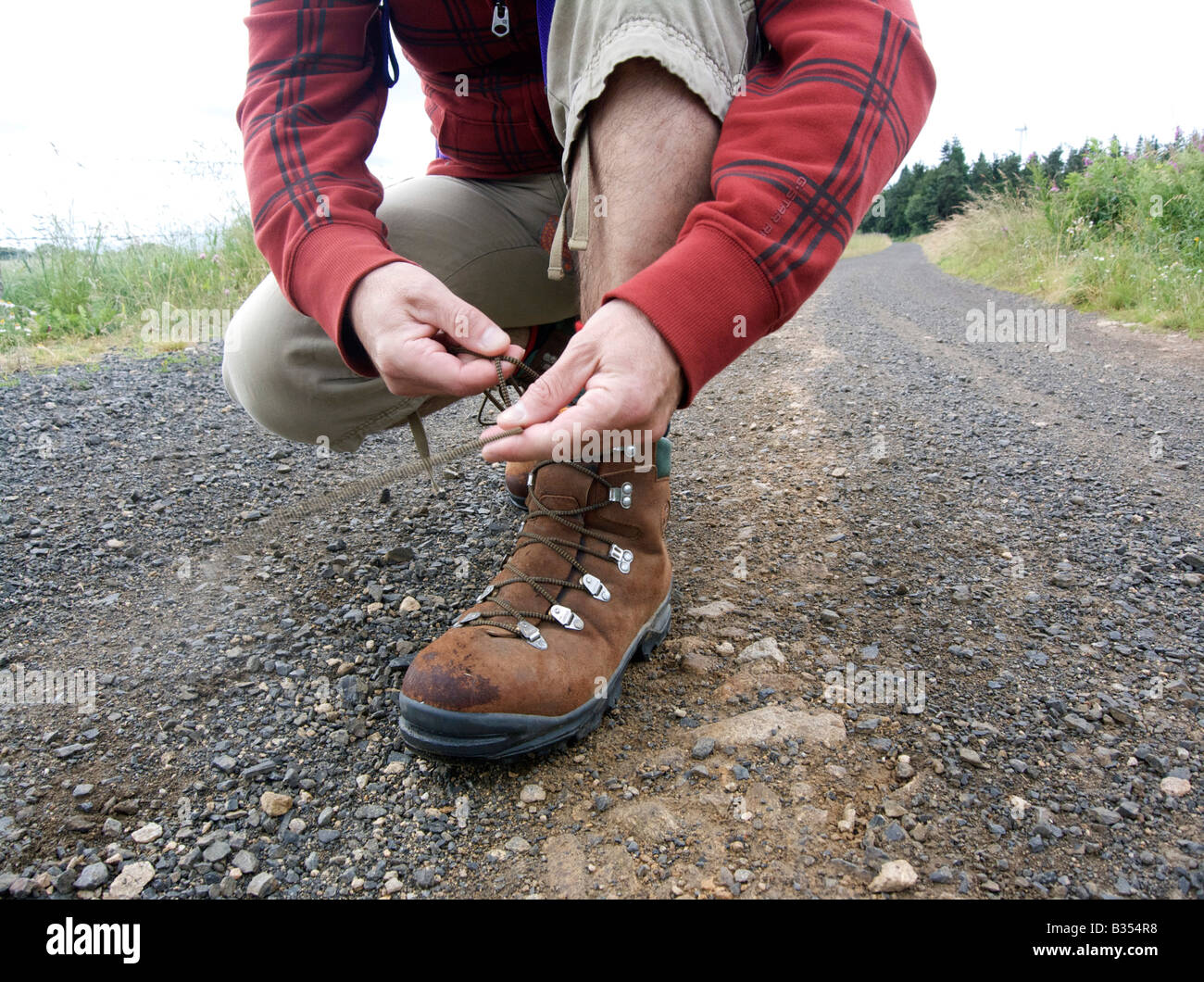 Man tying his walking shoes / boots laces Stock Photo