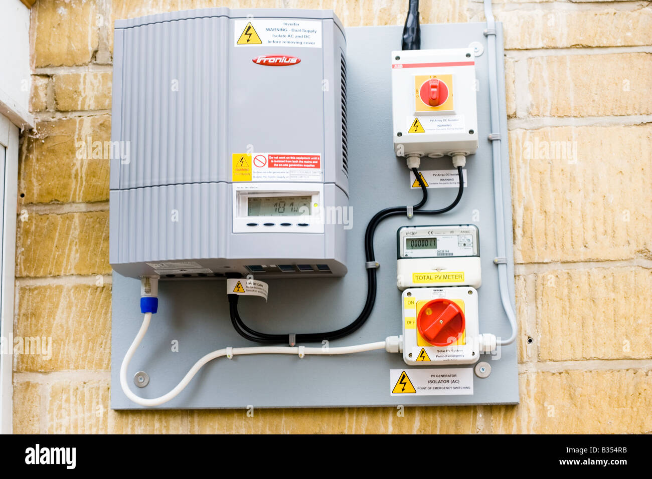 Wall mounted Fronius inverter to control array of 12 solar PV panels Cotswolds UK Stock Photo