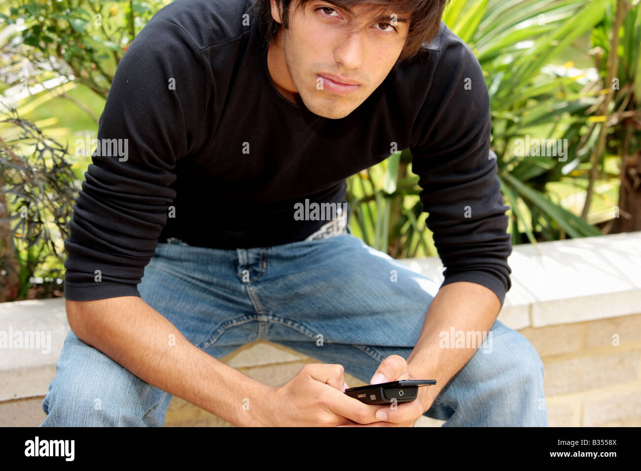 Young Man Texting on Mobile Phone Model Released Stock Photo - Alamy