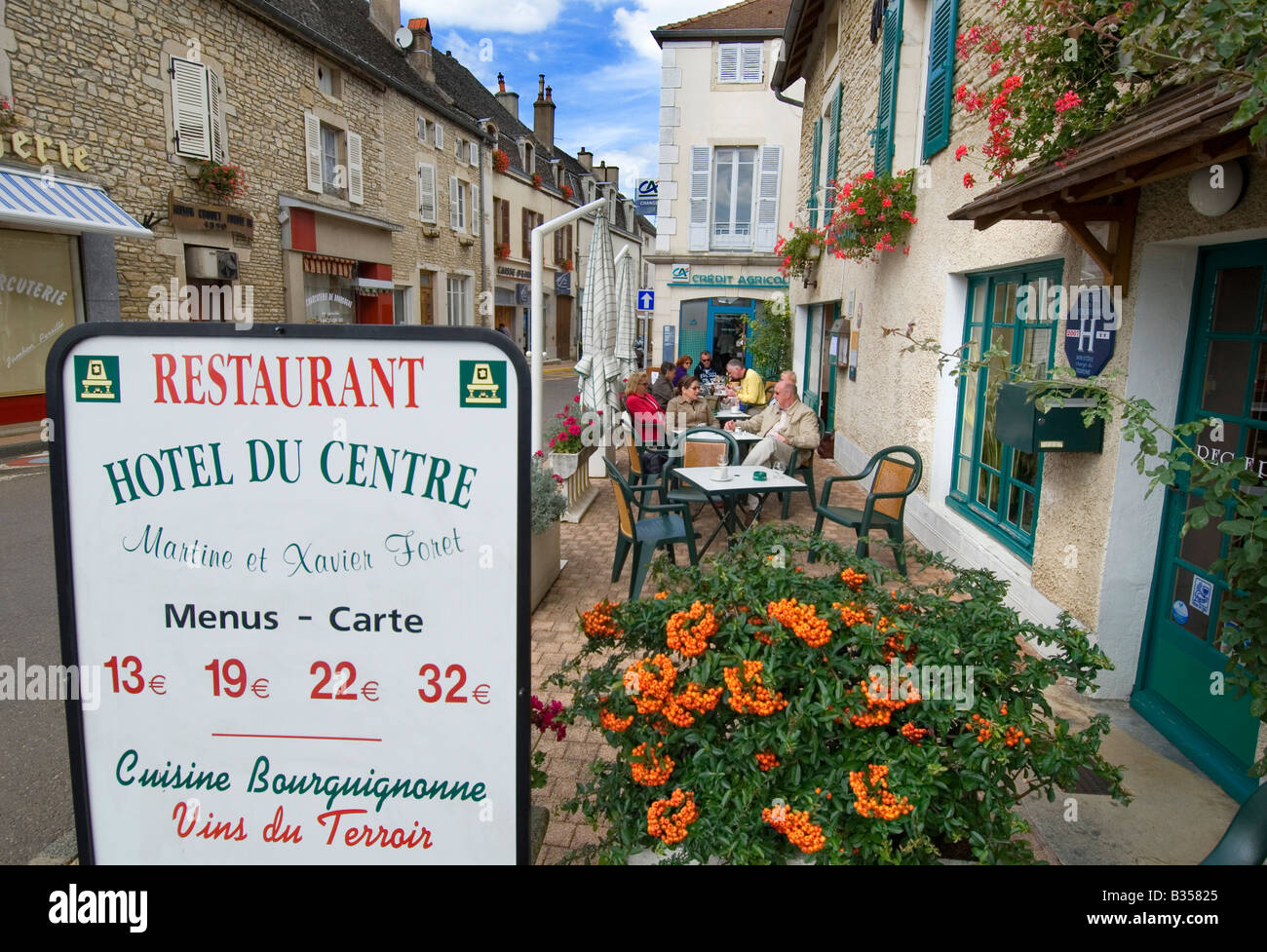 Typical value fixed price menu board, with visitors enjoying an alfresco drink at Hotel du Centre Meursault Cote d'Or France Stock Photo