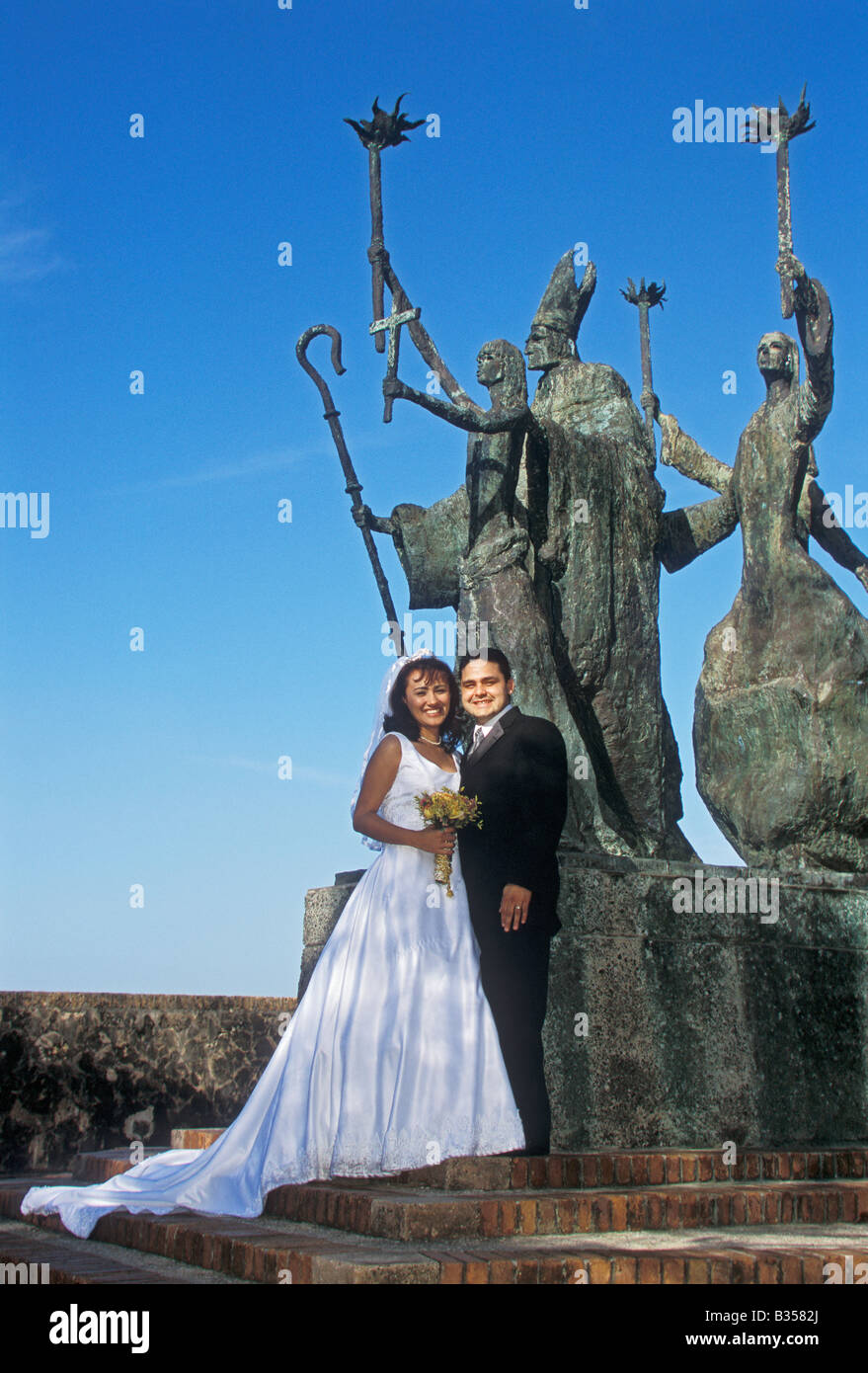 Couple posing for wedding photos at La Rogativa sculpture in Old San Juan Puerto Rico Stock Photo