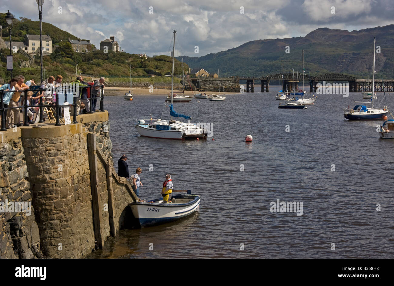 barmouth harbour mid wales showing passengers embarking on to a small  ferry boat Stock Photo