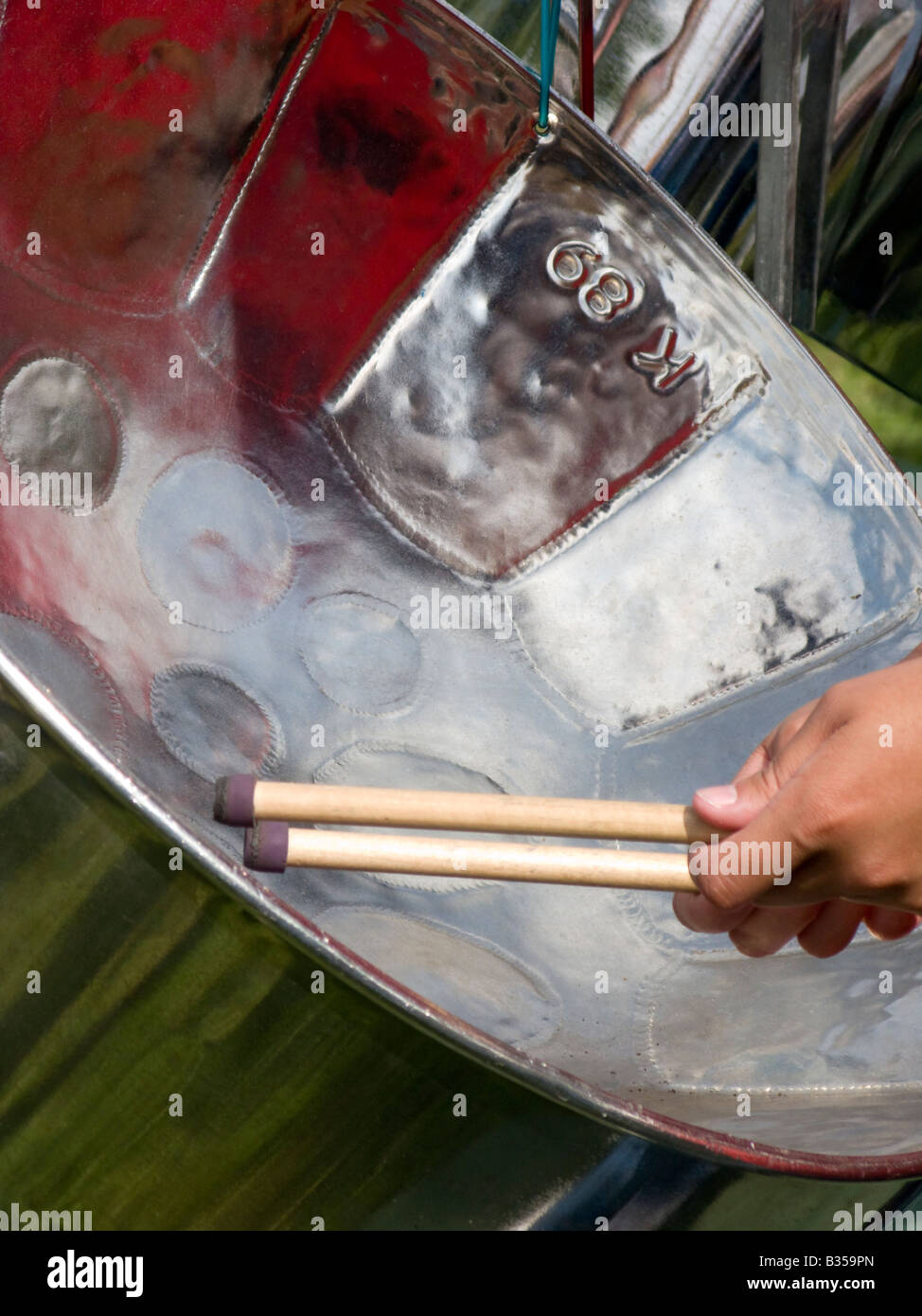 Hands and sticks of a steel drum player Stock Photo