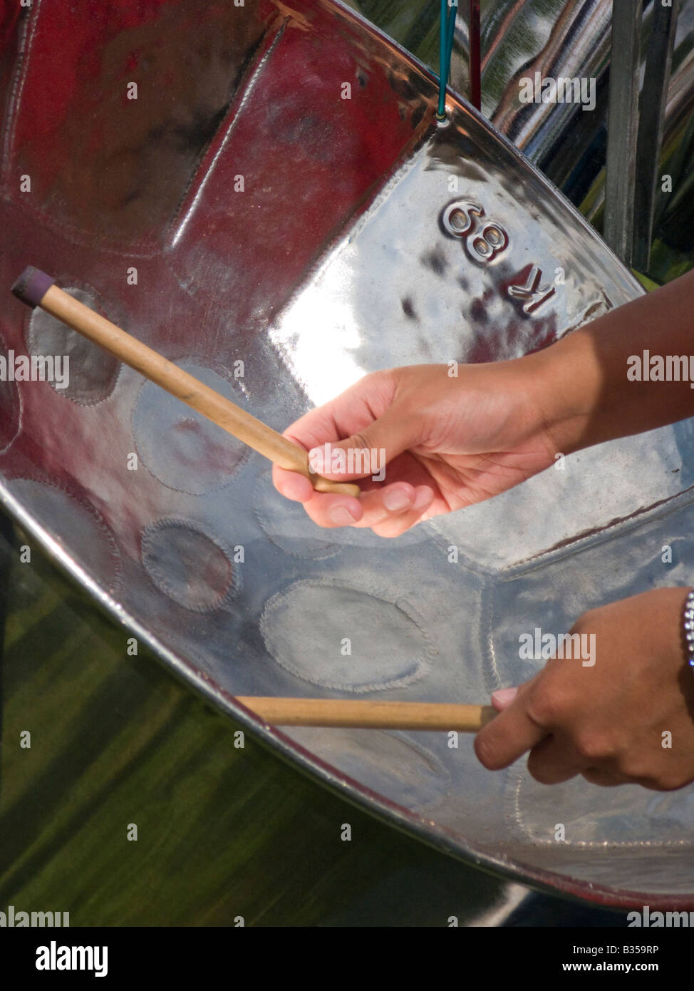 Hands and sticks of a steel drum player Stock Photo