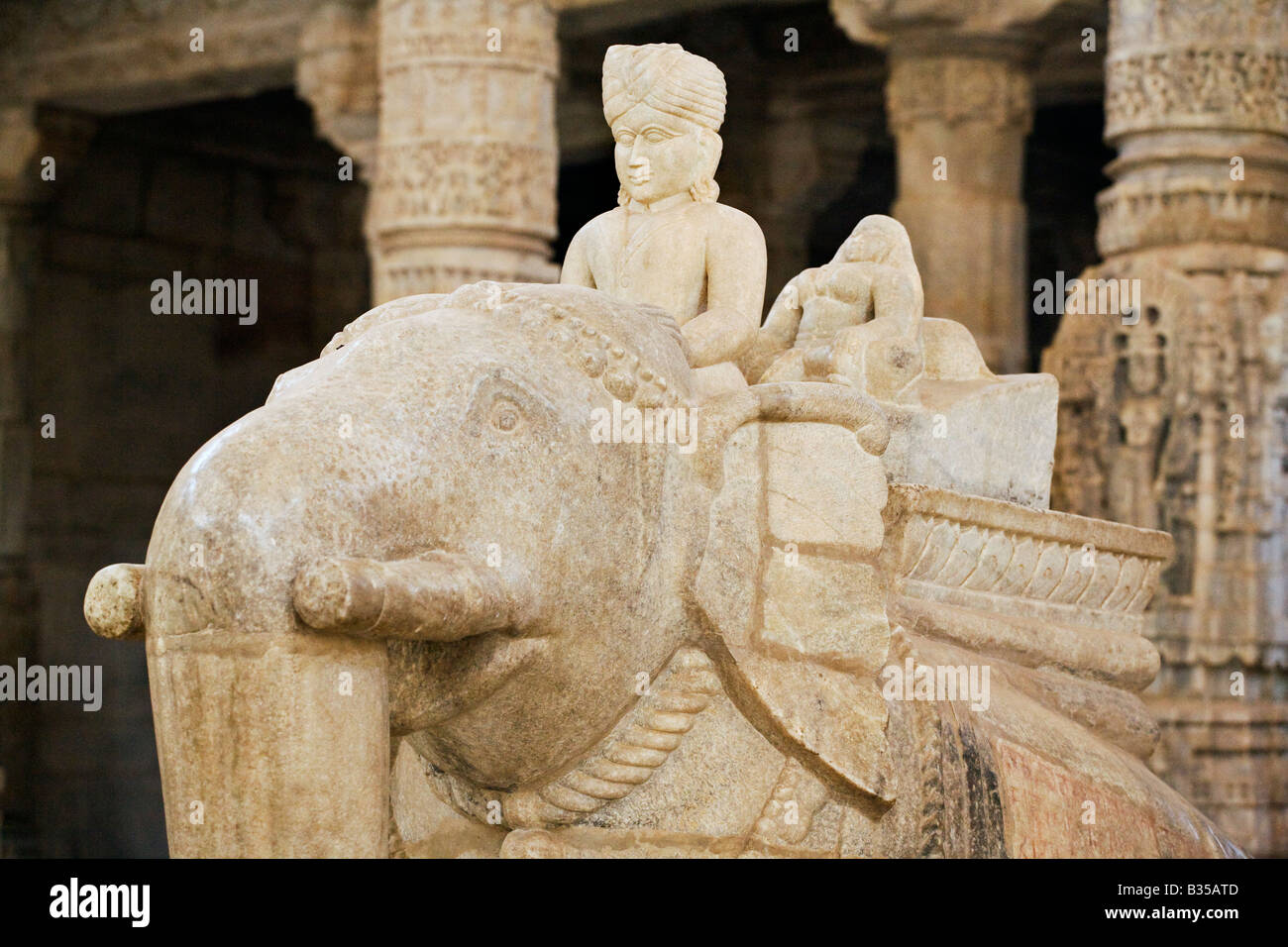 Carved white marble ELEPHANT and RAJPUT inside the CHAUMUKHA MANDIR TEMPLE at RANAKPUR RAJASTHAN near Sadri INDIA Stock Photo