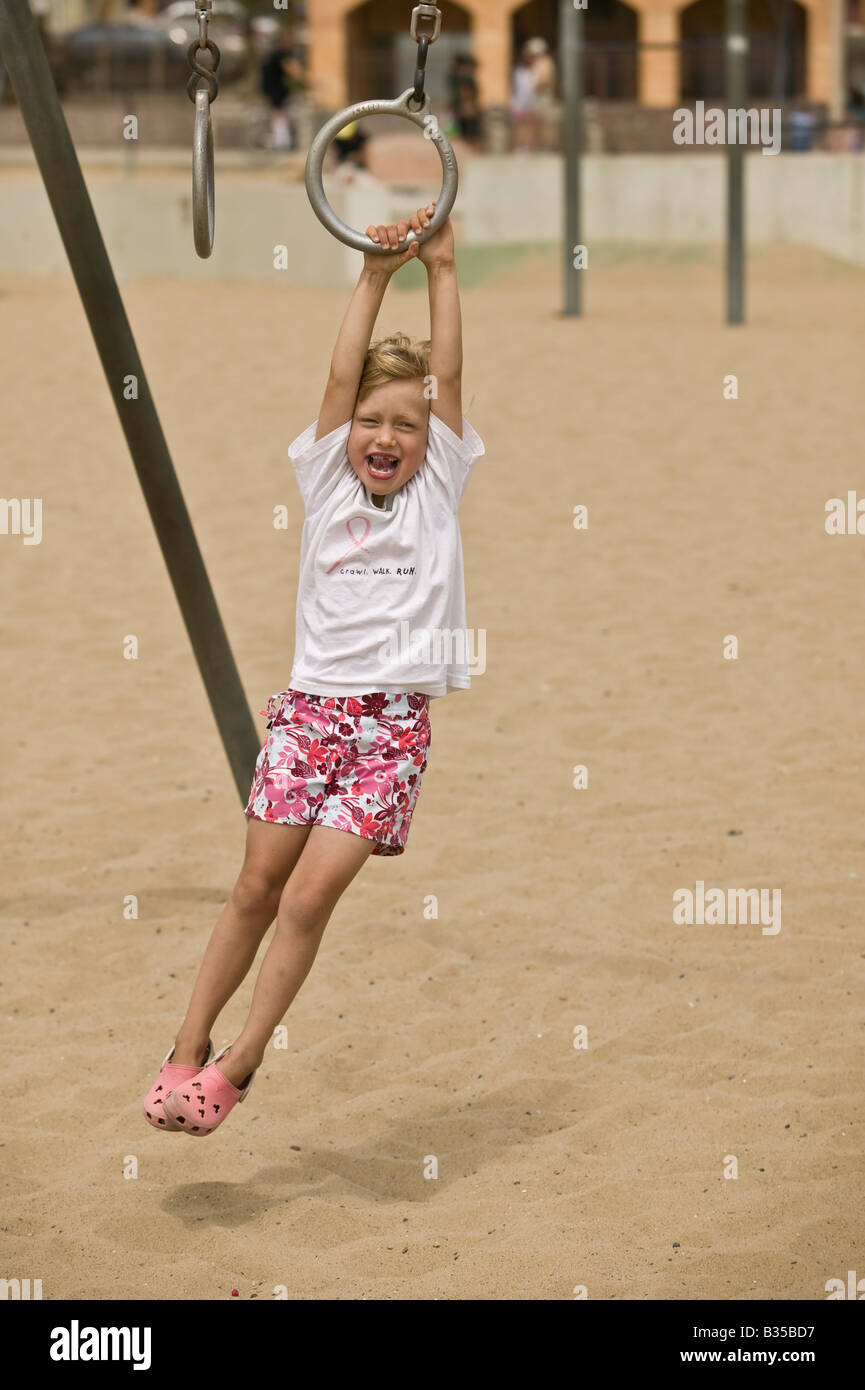 Girl swinging on rings Santa Monica, California, USA Stock Photo - Alamy