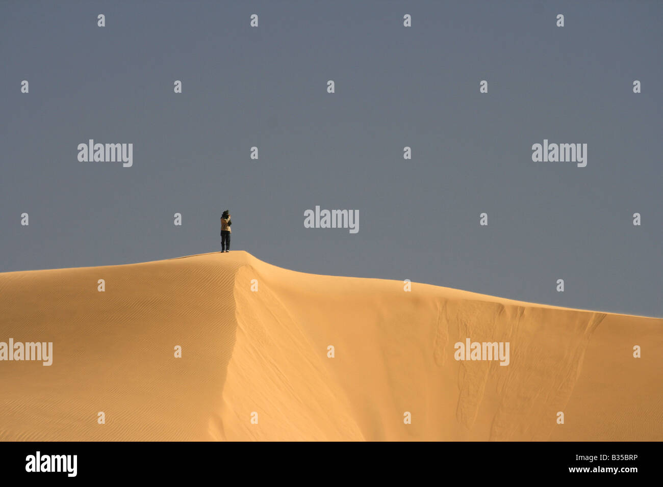 Person looking at on a sand dune In Akachaker Tassili Ahaggar Sahara ...