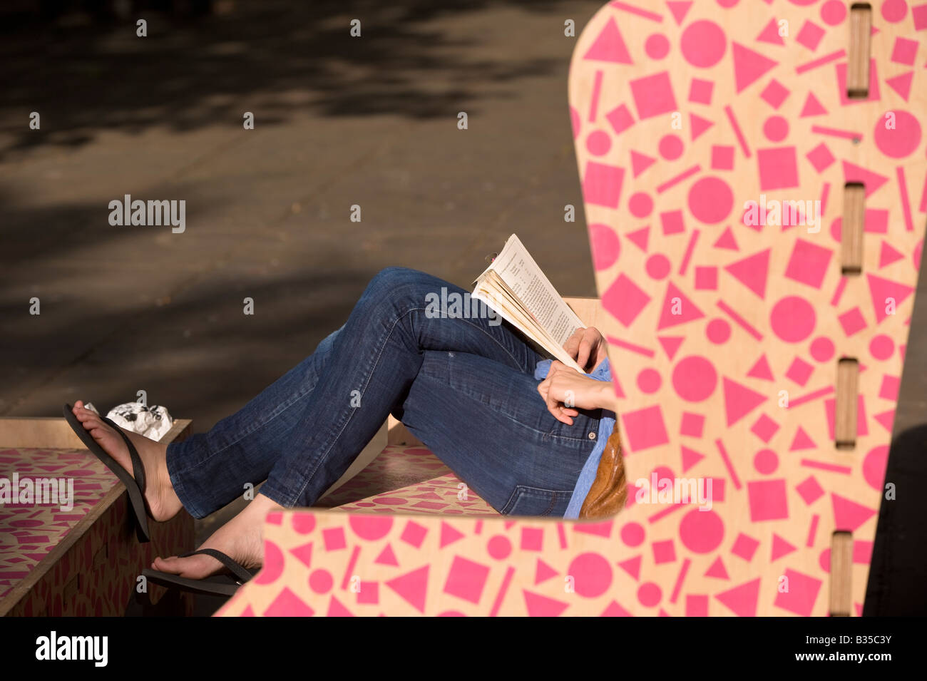 Girl reading book Sloane Square Chelsea SW3 London United Kingdom Stock Photo